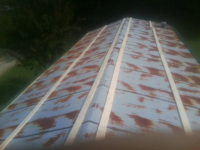Rusted metal roof panels with new wood purlins before replacement — Storm Damage Roof Repair in Indian Valley by Roofing Brothers