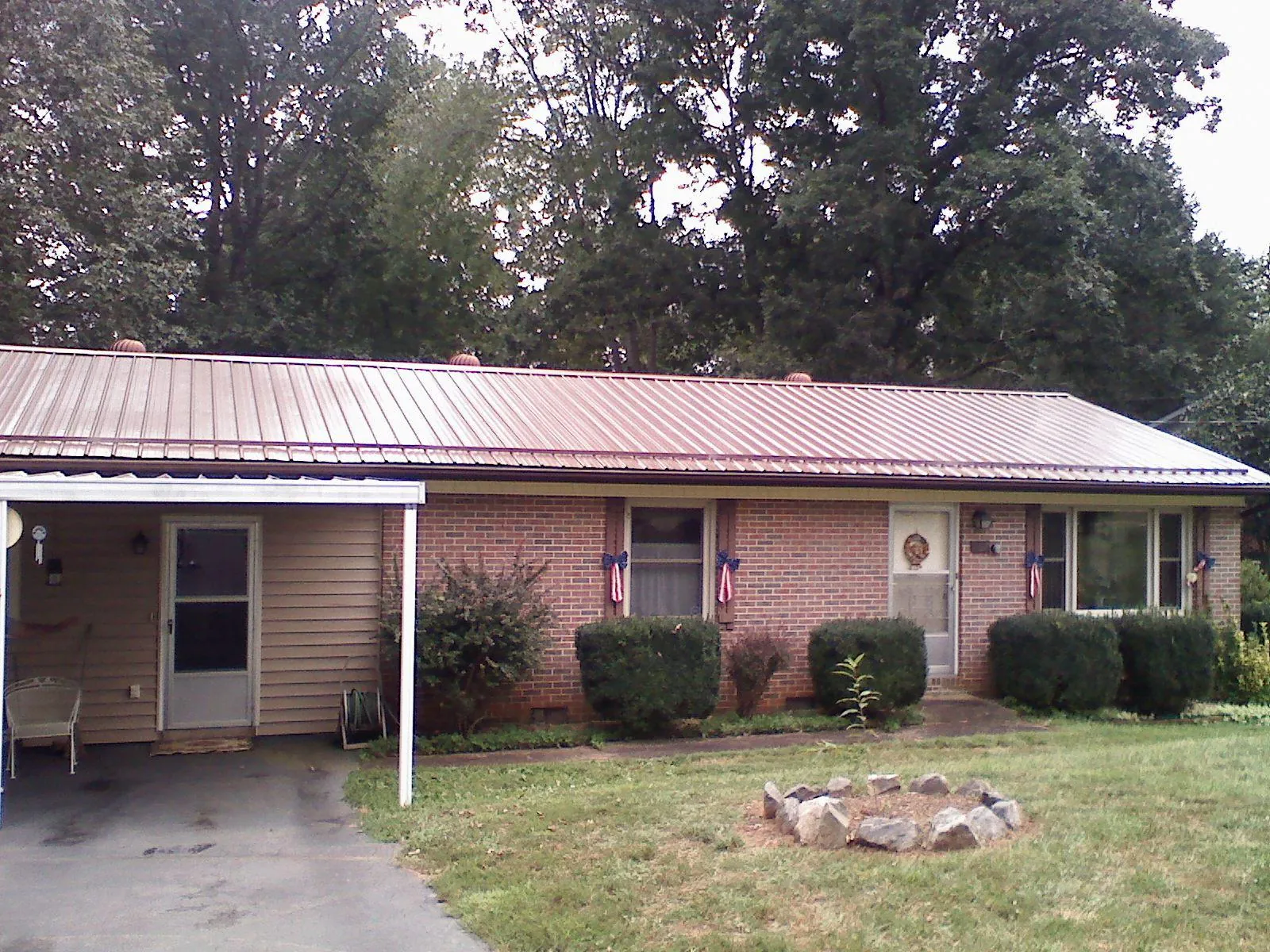 Bronze metal roof and carport on a brick ranch home — Roof Repair work by our crew in Indian Valley